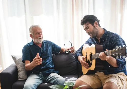 Two men playing a musical instrument for self-expression
